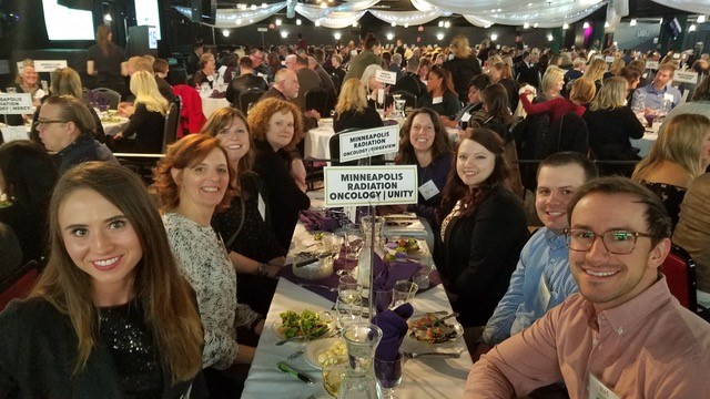 MRO staff around a dining table at a fundraising event.